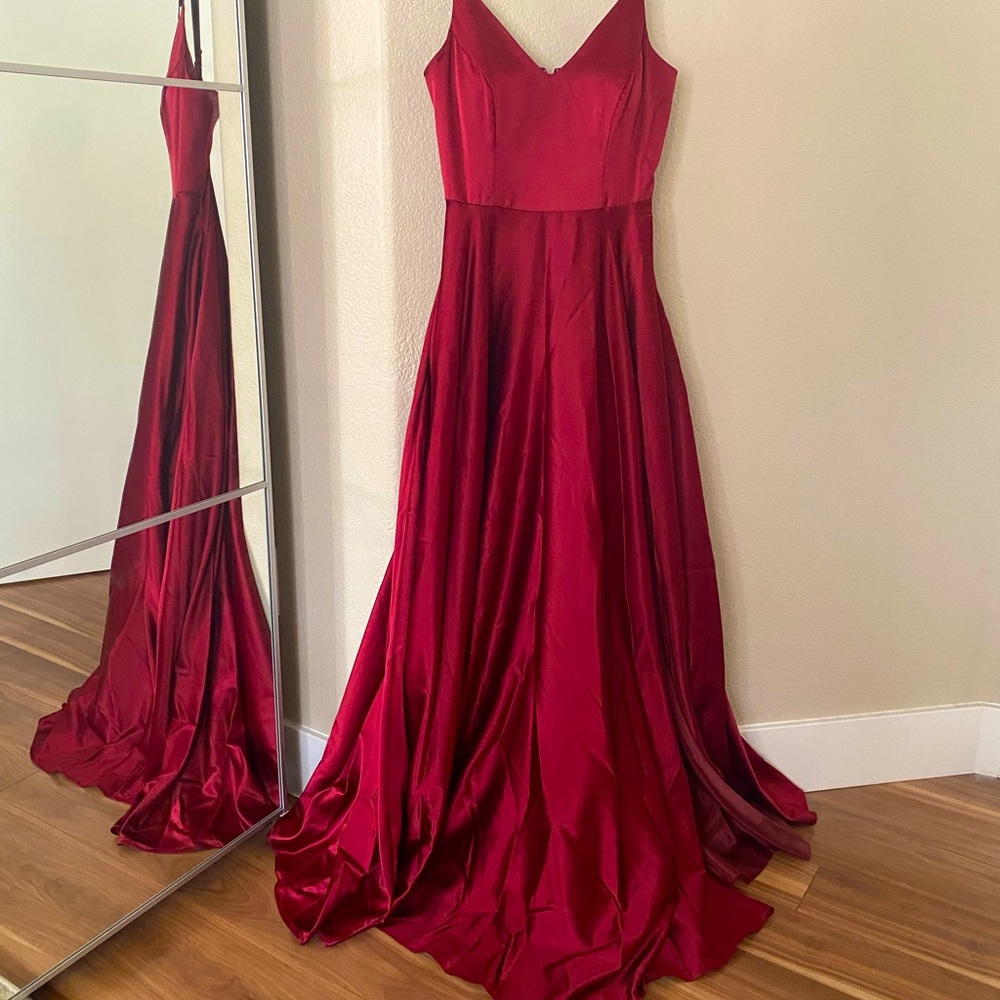 Red floor length satin gown.